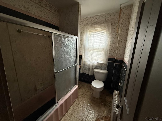 717-719 Messenger St, Johnstown, PA 15902 - bathroom with wallpapered walls, radiator, a wainscoted wall, enclosed tub / shower combo, and tile patterned flooring