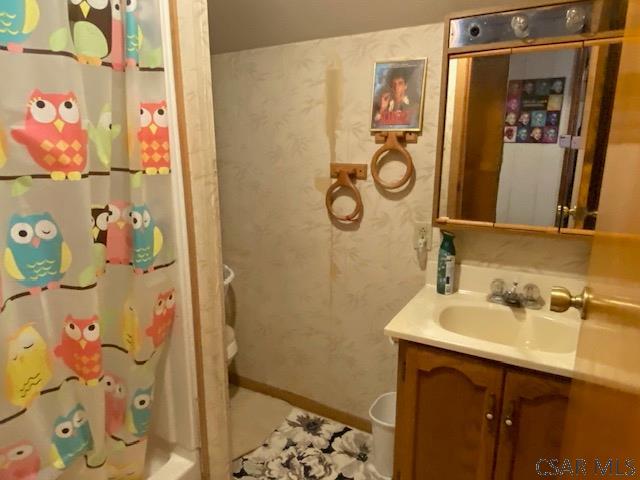 bathroom featuring vanity and shower / tub combo