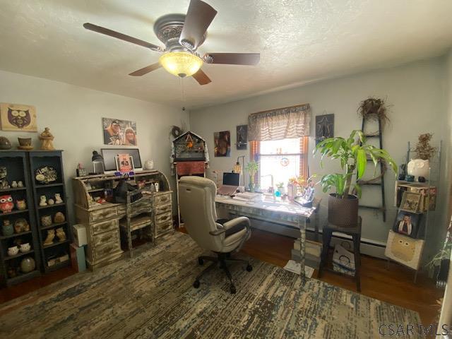 office area featuring dark hardwood / wood-style floors and ceiling fan