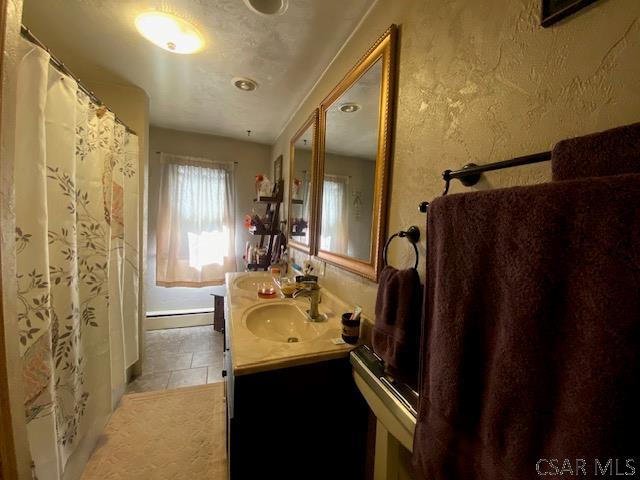 bathroom with tile patterned floors and vanity