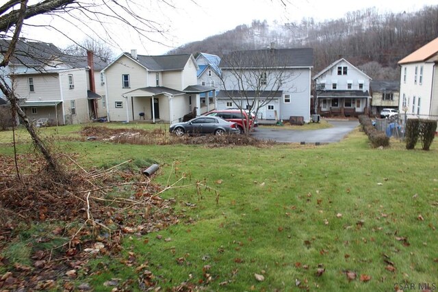 rear view of property featuring a yard