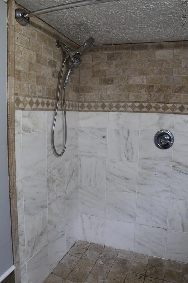 bathroom with a tile shower