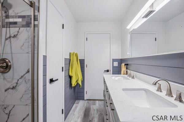 bathroom featuring a shower with door, vanity, and hardwood / wood-style floors