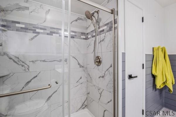 bathroom with a shower with shower door