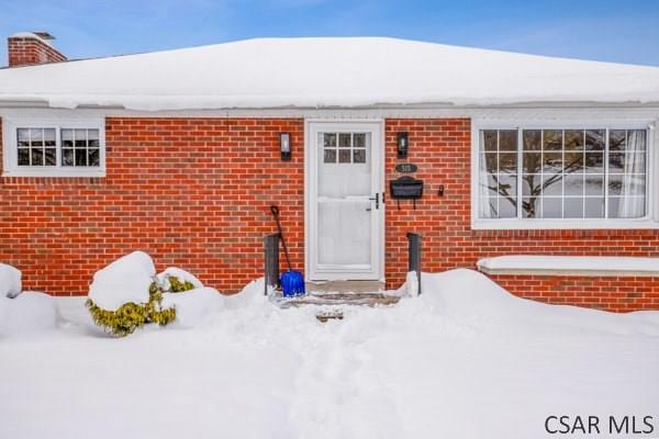 view of snow covered property entrance