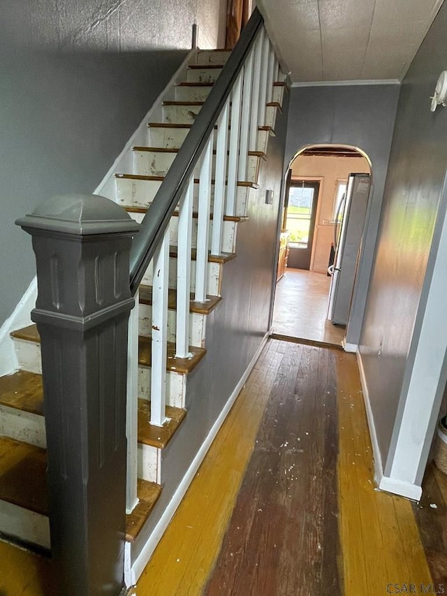 115 N St, Johnstown, PA 15906 - stairs featuring arched walkways, baseboards, and wood-type flooring