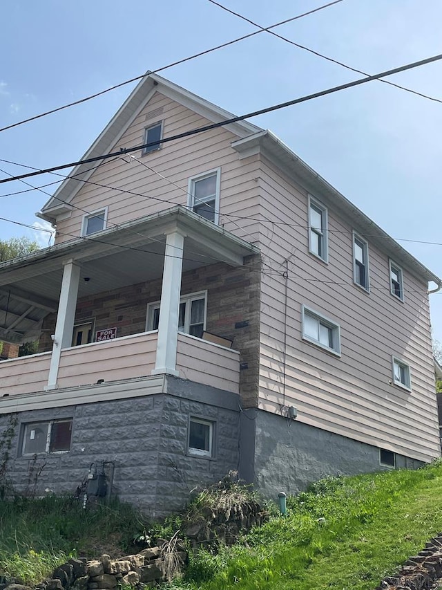 115 N St, Johnstown, PA 15906 - view of side of property featuring stone siding and a balcony