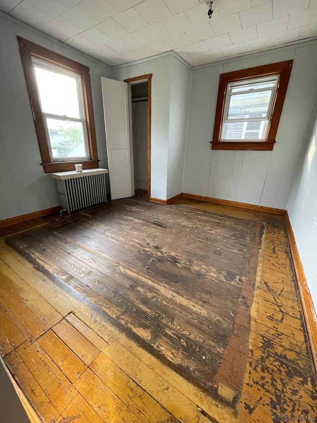 115 N St, Johnstown, PA 15906 - unfurnished bedroom with wood-type flooring, baseboards, and radiator