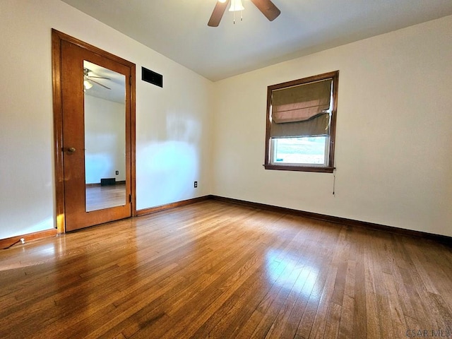 empty room featuring ceiling fan and hardwood / wood-style floors