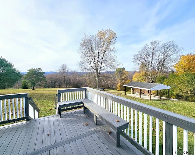 deck with a carport and a lawn