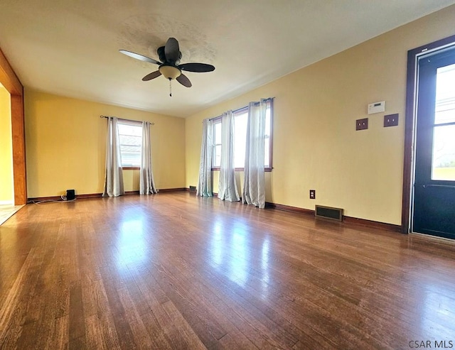 spare room with dark wood-type flooring and ceiling fan