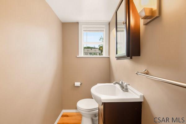 1082 W Main St, Somerset, PA 15501 - half bath with vanity, toilet, baseboards, and wood finished floors
