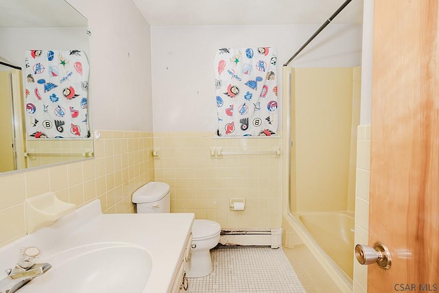 full bath featuring tile walls, a baseboard radiator, toilet, wainscoting, and tile patterned flooring