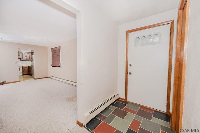 carpeted entrance foyer featuring baseboard heating and baseboards