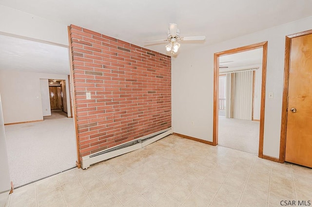 empty room featuring a baseboard heating unit, brick wall, a ceiling fan, baseboards, and carpet