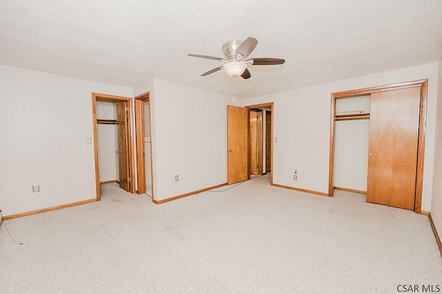 unfurnished bedroom featuring light carpet, a closet, and baseboards