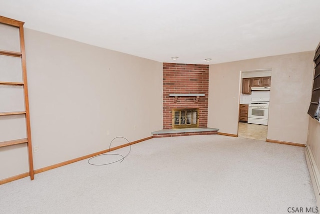 unfurnished living room with light carpet, a fireplace, and baseboards