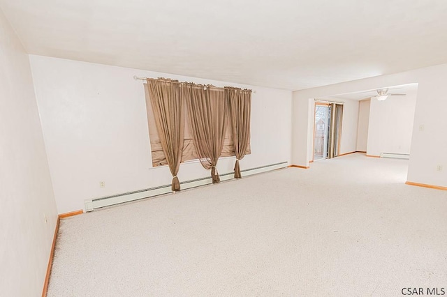 carpeted empty room with a baseboard heating unit, baseboard heating, a ceiling fan, and baseboards