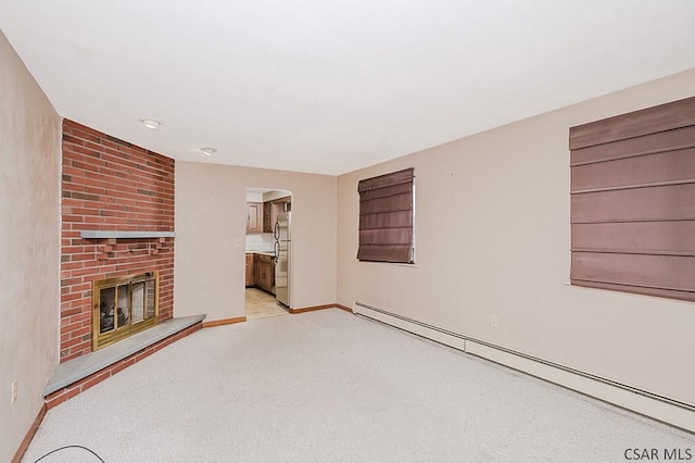 unfurnished living room with a brick fireplace, light carpet, baseboards, and baseboard heating