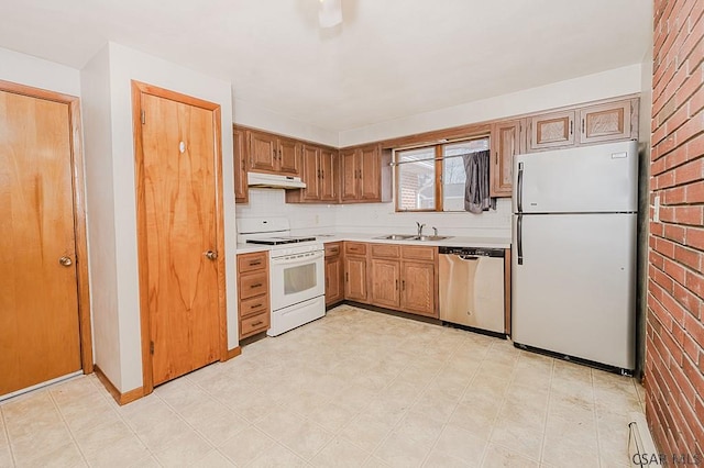 kitchen featuring light countertops, decorative backsplash, a sink, white appliances, and under cabinet range hood