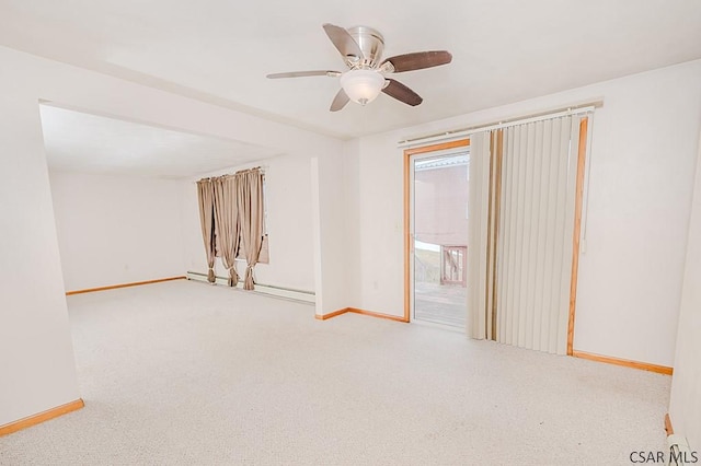 carpeted spare room with baseboards and a ceiling fan