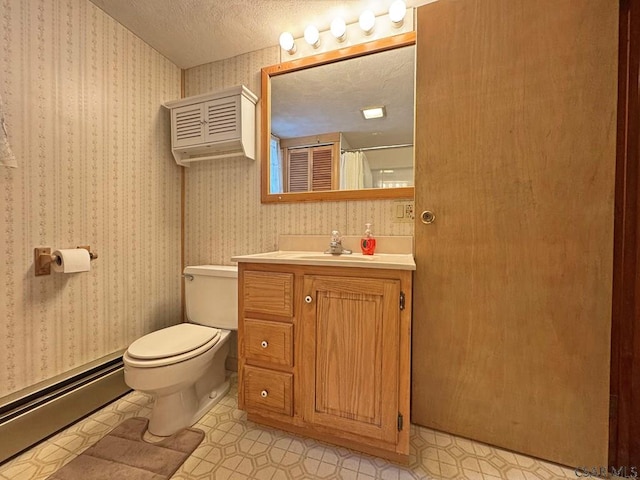 bathroom with a baseboard radiator, vanity, walk in shower, toilet, and a textured ceiling