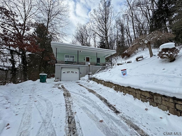 view of front of house with a garage and covered porch