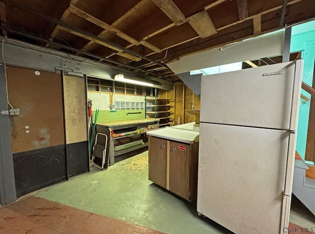 basement with white refrigerator