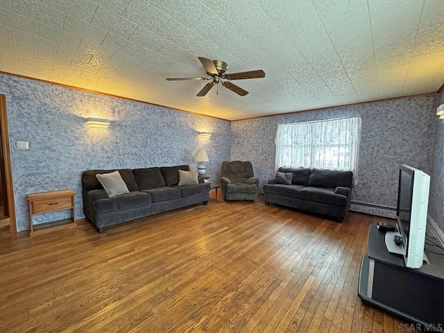 living room featuring hardwood / wood-style flooring, ornamental molding, and ceiling fan