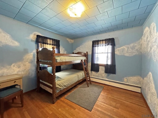 bedroom featuring a baseboard radiator and hardwood / wood-style floors