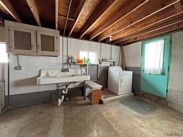 basement featuring sink and washing machine and dryer