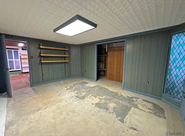 interior space with concrete floors and wood walls