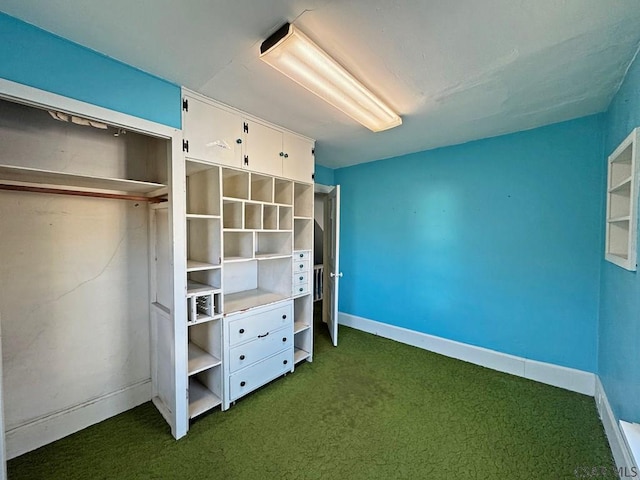 unfurnished bedroom with baseboards and dark colored carpet