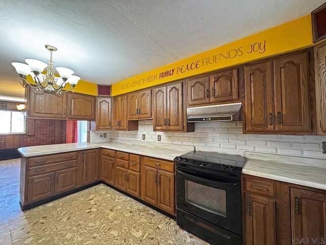 kitchen with light countertops, black range with electric cooktop, a peninsula, and under cabinet range hood