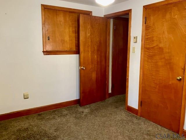 unfurnished room featuring baseboards and carpet floors