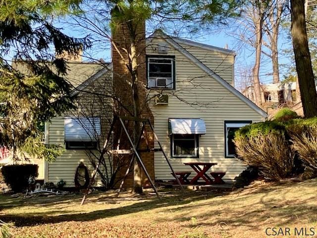 rear view of property with a chimney