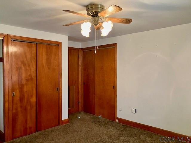 unfurnished bedroom featuring carpet flooring, ceiling fan, and baseboards