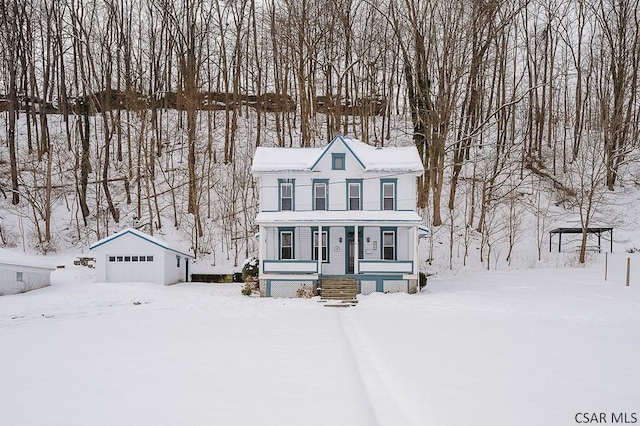 view of front of property with a garage and an outdoor structure