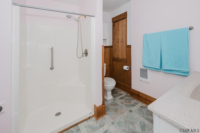 bathroom featuring vanity, toilet, and walk in shower