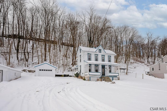 view of front of house with an outbuilding, a garage, and a porch