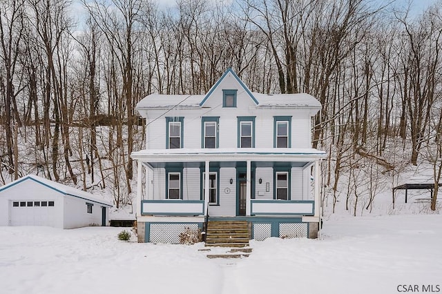 view of front of property featuring an outbuilding, a garage, and a porch