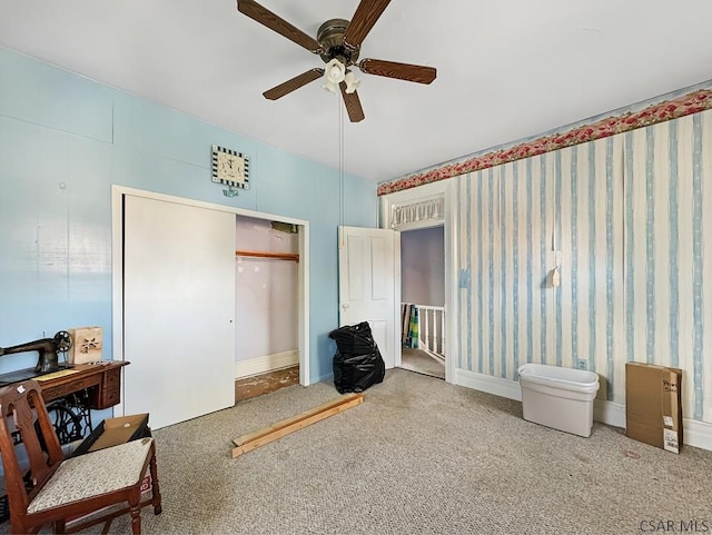 interior space featuring ceiling fan, carpet, and a closet