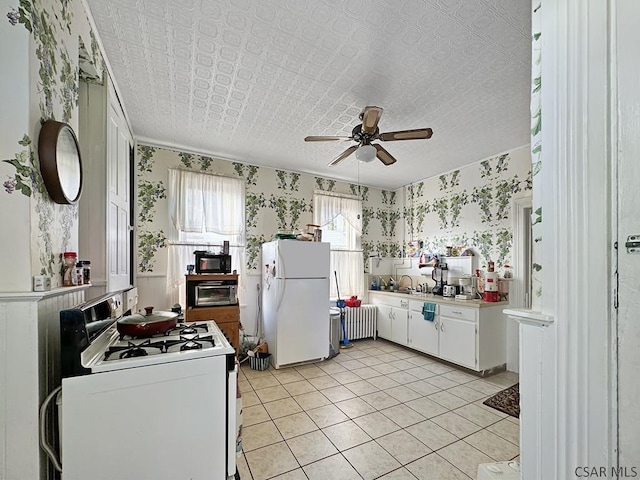 kitchen with white cabinetry, a textured ceiling, light tile patterned floors, ceiling fan, and white appliances