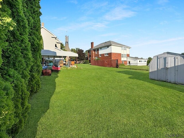 view of yard with a carport and a shed