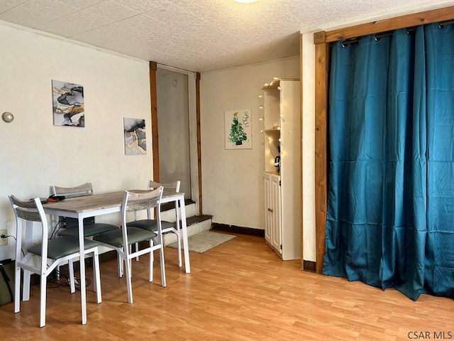 dining space with light hardwood / wood-style flooring