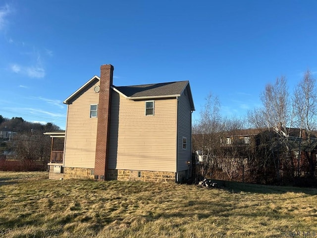 view of side of property with a yard and a sunroom