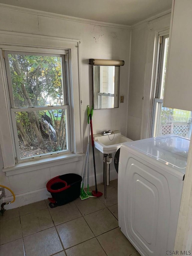 bathroom featuring tile patterned flooring, washer / clothes dryer, plenty of natural light, and ornamental molding