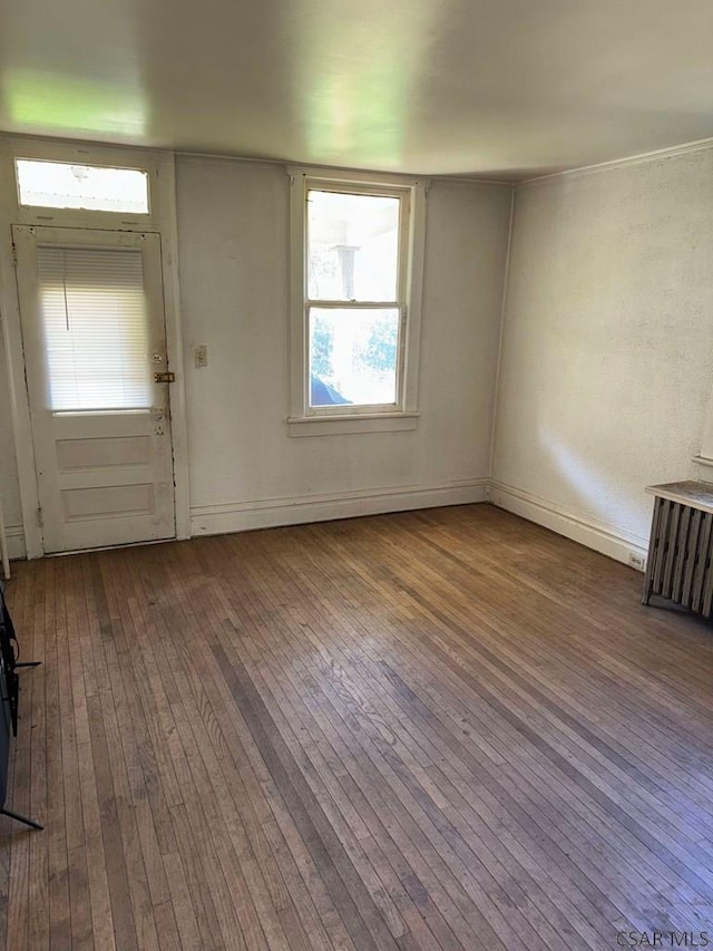 foyer with hardwood / wood-style flooring and radiator