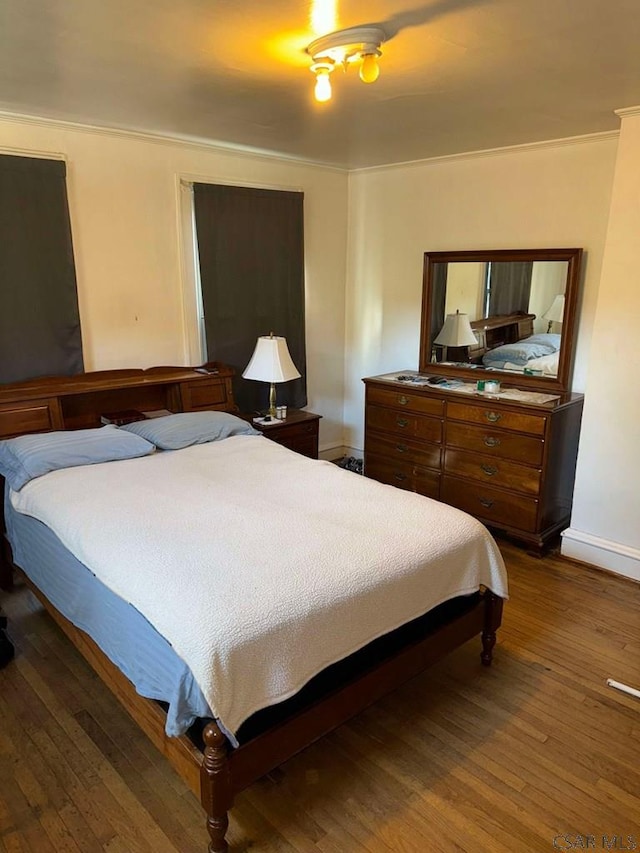 bedroom with dark hardwood / wood-style floors