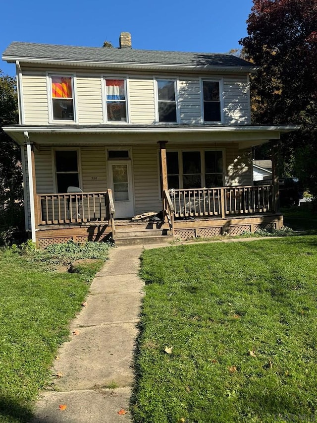 farmhouse-style home with covered porch and a front lawn